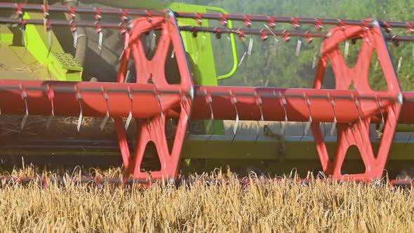 Close Up of Modern Combine Harvest at Work. Low Angle.