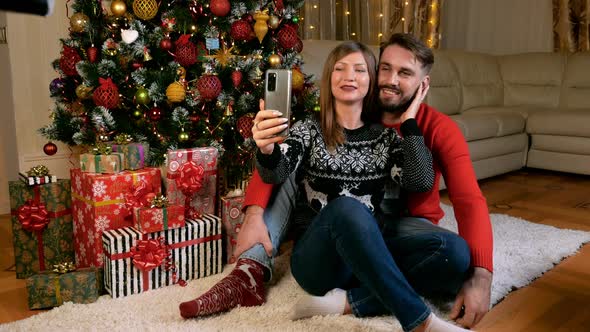 Young Multiethnic Couple Making Selfie Xmas