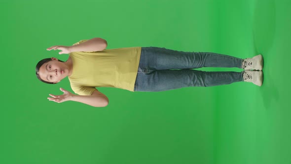 Young Asian Kid Girl Opening Her Eyes With Palms, Surprised And Saying Wow In The Green Screen