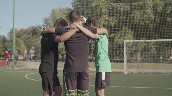 Street Soccer Team Embracing Before Football Game