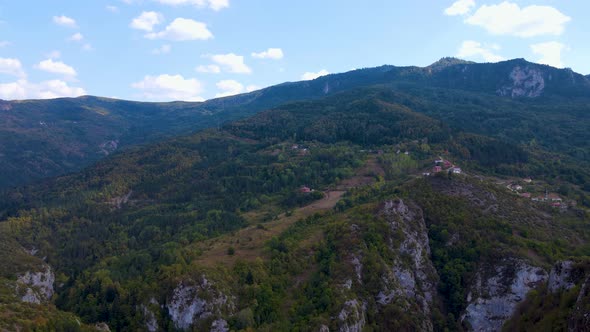 Steep green mountains, deep forest and mountain road, beautiful valley  