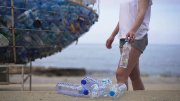 Plastic Bottles on Sea Ocean Beach Next to Special Place for Garbage and Young Caucasian