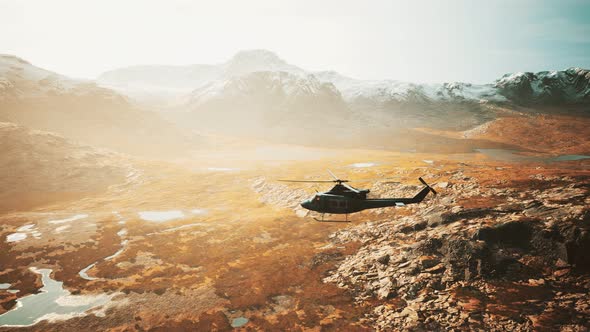 Slow Motion Vietnam War Era Helicopter in Mountains alt