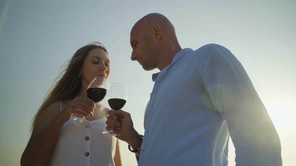 Couple Drinking Wine and Looking at Each Other