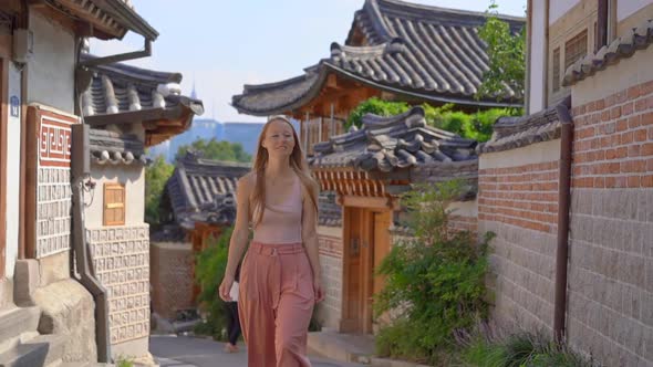 Young Woman Visits the Busy Touristic Historical Street Bukchon Hanok Village in a Center of Seoul