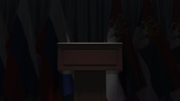 Many Flags of Serbia and Russia Behind Speaker Tribune