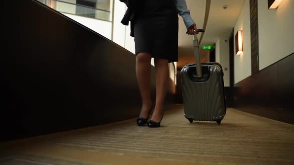 Businesswoman Carrying Suitcase to Hotel Room