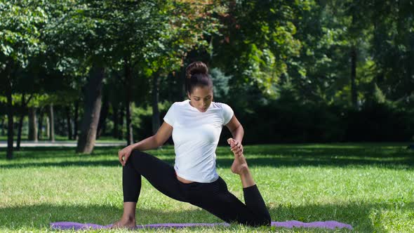 Woman Doing Yoga in the Park on a Beautiful Day