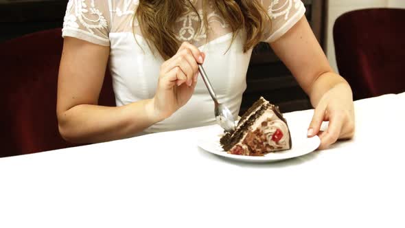 Business woman eating a chocolate cake