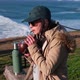 woman drinking mate, typical Argentine drink, on the beach, watching the sunset pichilemu, chile. - VideoHive Item for Sale
