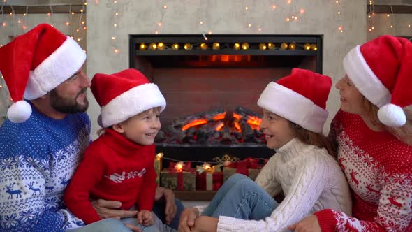 Family near fireplace in Christmas