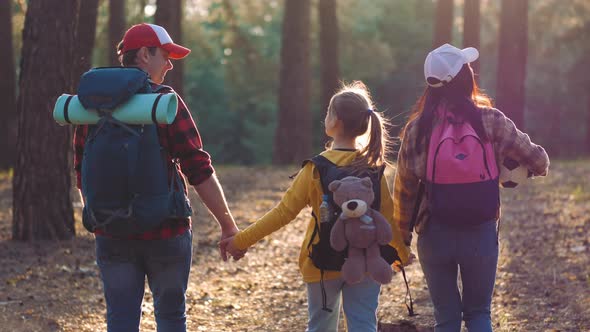 Happy Family Hiking Through a Forest