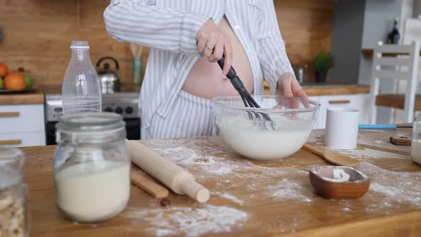 Pregnant Woman Cooking Food On Kitchen.