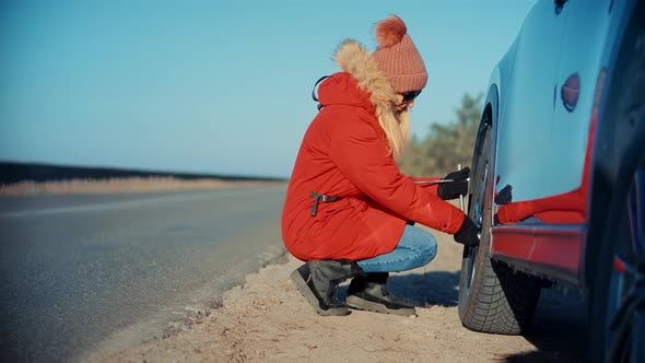 Woman Check Car Tire Pressure. Vehicle Trouble On Road On Vacation Trip. Female Trying Fix Car Tire.