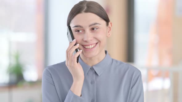 Portrait of Young Latin Woman Talking on Smartphone