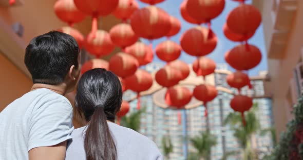 Couple enjoy look at the red lantern in the street