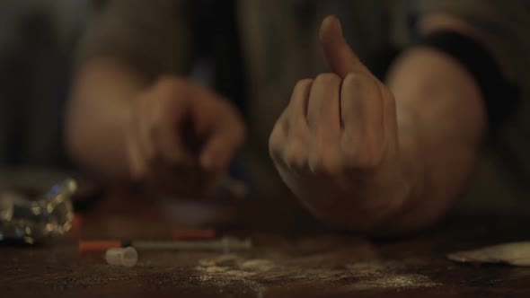 Hand of Depressed Man Making Drug Injection With Syringe at Abandoned Place