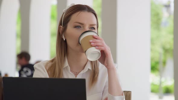 Concentrated Young Caucasian Businesswoman Drinking Coffee Outdoors RED Footage