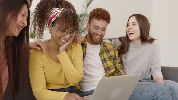 Group of Young Multiracial Friends Having Fun Using Laptop Computer at Home alt