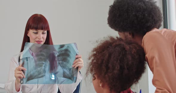 Female Pediatrician Holding a Lung Xray in Her Hands