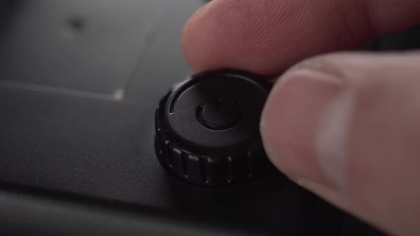 A black start button and power adjustment device with a plastic case 