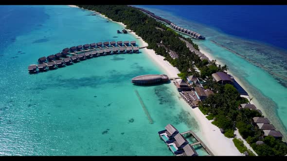 Aerial top down tourism of idyllic tourist beach holiday by blue ocean and white sandy background of