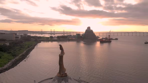 Aerial shot of Kun Iam statue and Macau Science Centre in front of stunning sunrise