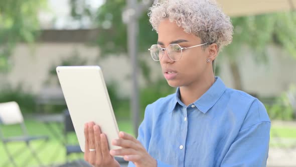 Portrait of Young African Woman Reacting to Loss on Tablet