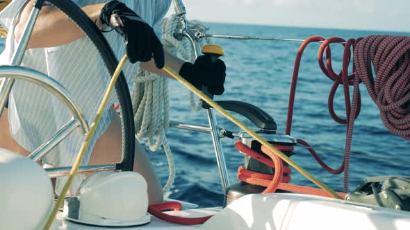 Ropes Onboard of a Yacht Are Getting Unreeled By a Woman