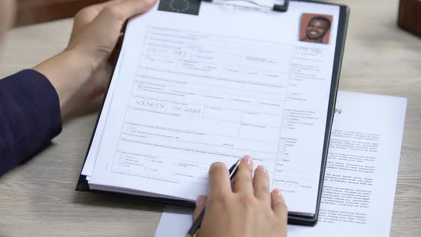 Manager Checking Schengen Zone Visa Application, Signing Deportation Documents