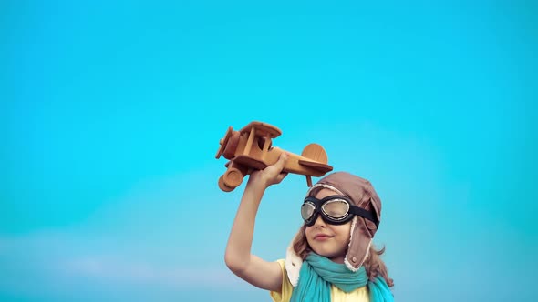 Happy Kid Playing with Airplane Outdoors alt