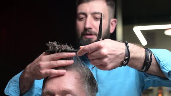 The work of a master with a client's hair in a barbershop, close-up