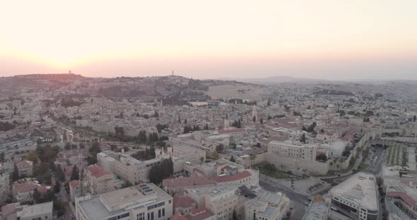 Fly down twilight hour, red sunset over Jerusalem city, aerial view, drone.