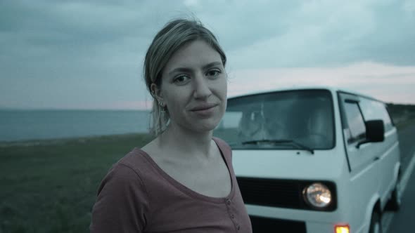 Portrait of Cheerful Woman Posing for Camera by Camper Van