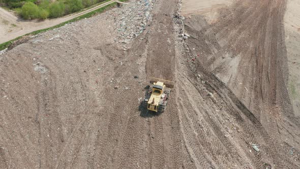 Special Tractor Sorting Waste at City Landfill