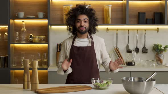 Arabian Man Shares Recipe of Salad at Table in Kitchen