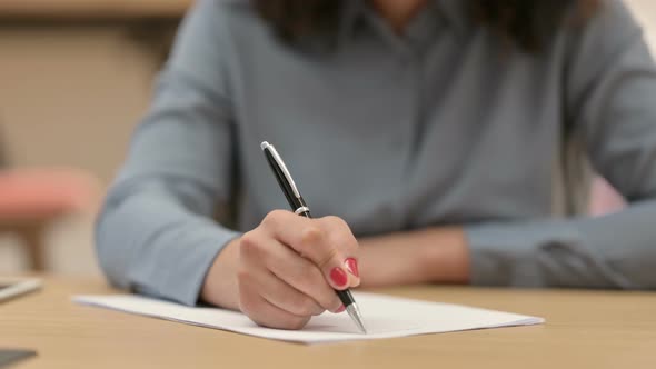 Close Up of African Woman Writing on Paper