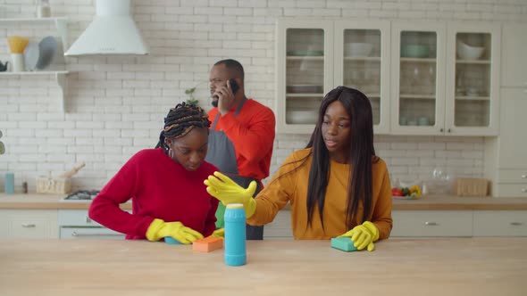 Cute Black Teenage Girls Cleaning Kitchen with Cleanser