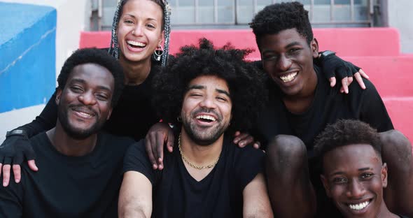 Group of young multiracial people smiling on camera outdoor