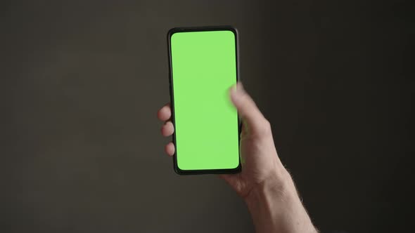 POV Top View Shot of Man Using Phone with Green Screen Indoor