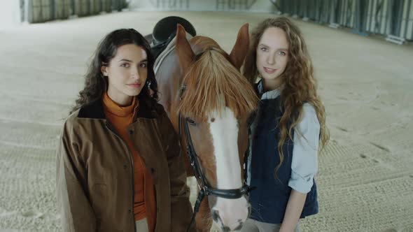 Portrait of Two Pretty Women with Chestnut Horse