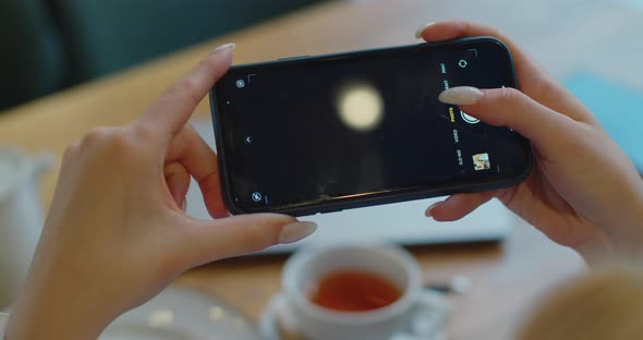 POV Shot Female Hands Photographing Food on Table Using Smartphone