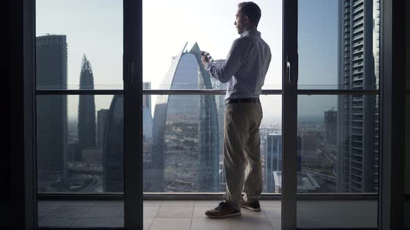 Young Business Man Succeed in Finance Career Standing on Modern Office Cityscape Balcony