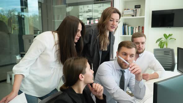 Businessman Discussing Work with Team in Boardroom