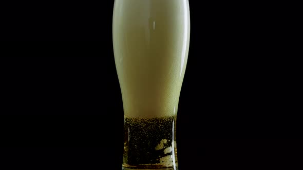 Light Beer In A Glass On A Black Background Close Up