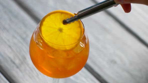 Tongs Put Orange Into Cocktail