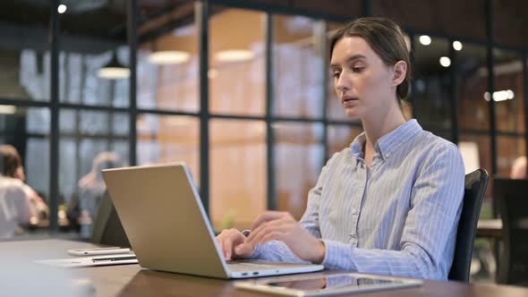 Pensive Young Woman Thinking at Work Brainstorming