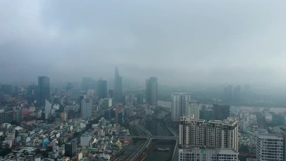 Saigon, Ho Chi Minh City, Vietnam. Dramatic view of City skyline with key buildings. Morning fog, su