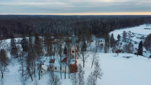 Aerial Top View of the Krimulda Evangelic Lutheran Church in Winter at Sunrise Latvia 4k Video