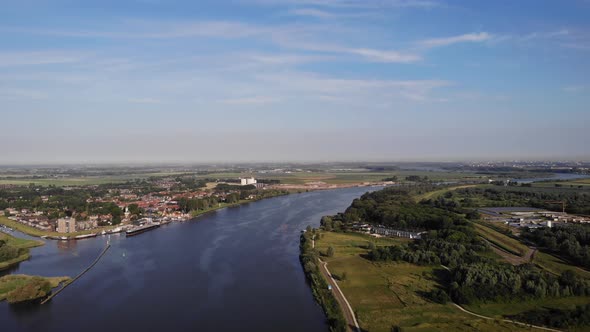 Aerial View Over Oude Mass With Town Of Puttershoek In Background. Slow Tracking Shot